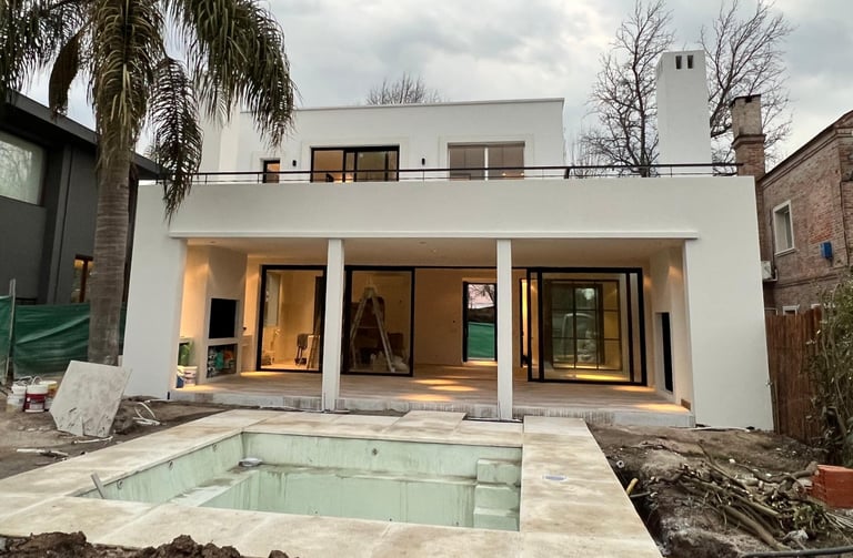 a house with a pool and a palm tree