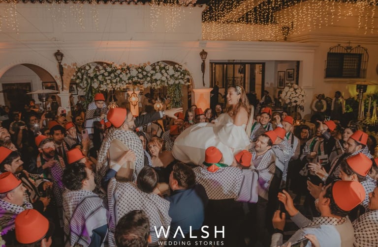 Bride and groom lifted on chairs