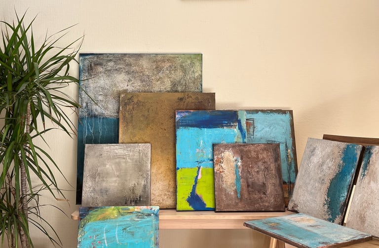 Different textured abstract paintings are staged