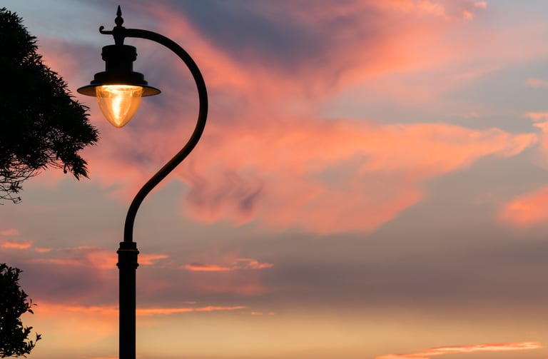 a street light on Lugard Road Hong Kong with a sunset in the background