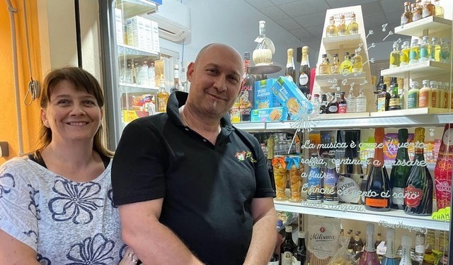 a man and woman standing in front of a store