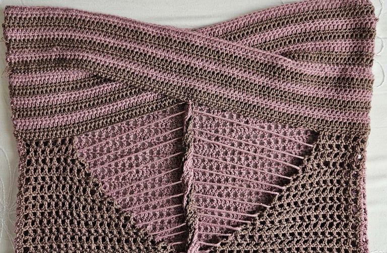 Handmade pink and brown striped crochet tube top with a cross-front design and mesh stitch detail.