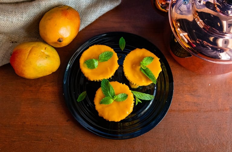 Mango lassi cheescake varnished with a mint leaf on top- plated