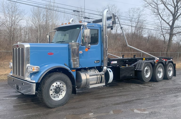 blue Peterbilt roll-off truck