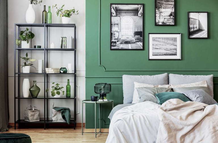 painting serivce dubai a bedroom with green walls and a bed with a white bed and a green wall