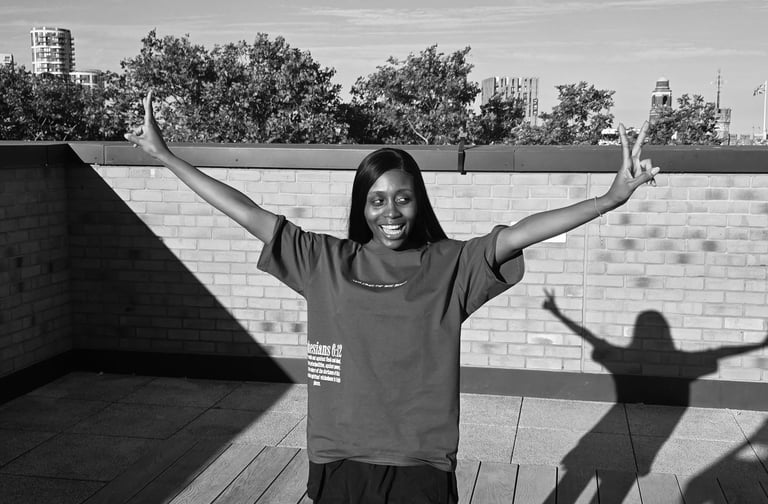 a woman standing on a deck with her arms up