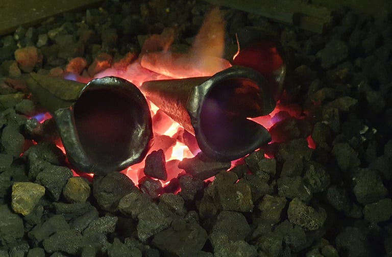 steel calla lilly in forge with glowing coals