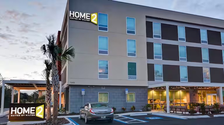 a hotel with a car parked in front of a building