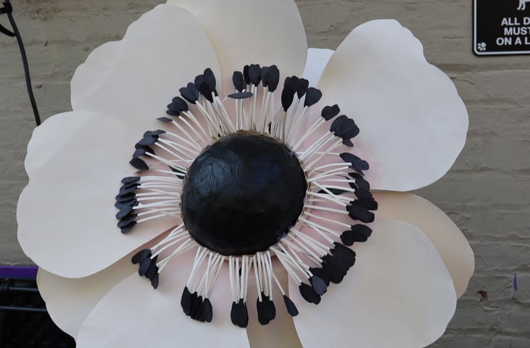 a paper flower with black and white flowers