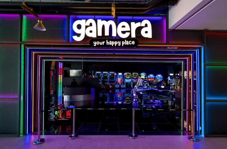 a storefront door with a neon - lit sign that says gamera