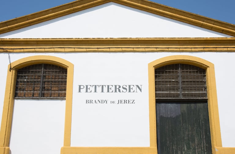 Depicting the grand main entrance of Pettersen Brandy's bodega located in Jerez de la Frontera.