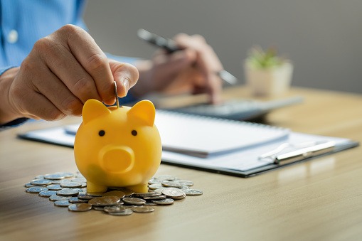 imagem de um jovem guardando dinheiro para investir futuramente em um financiamento