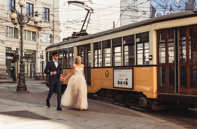 a bride and groom walking down the street in Milan