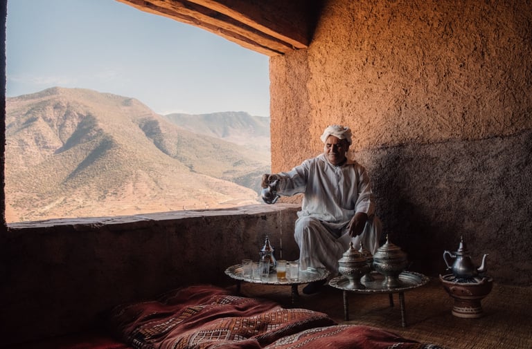 Moroccan Bedouin in the atlas desert behind argan tree 