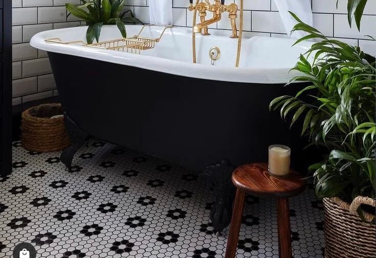 penny mosaic tiles under the tub in bathroom