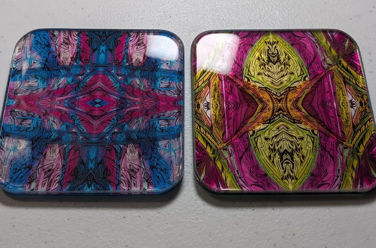 two square shaped coasters with a colorful pattern