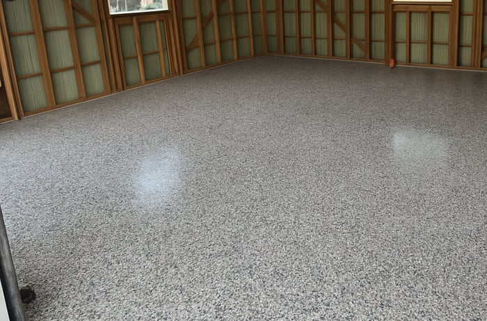 Decorative flake garage floor coating installed in residential garage