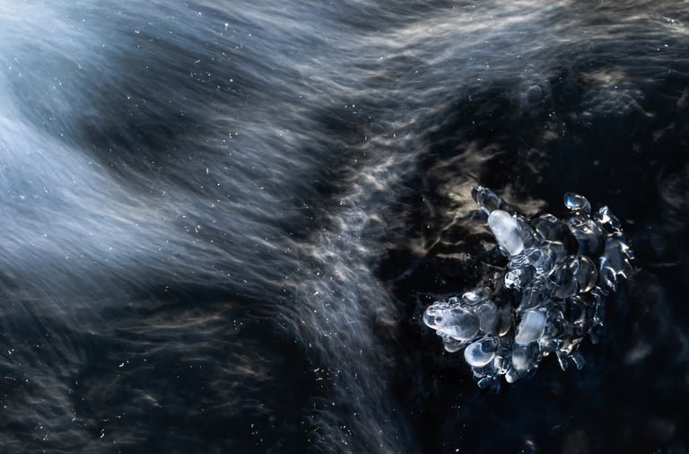 a piece of ice with water and ice crystals