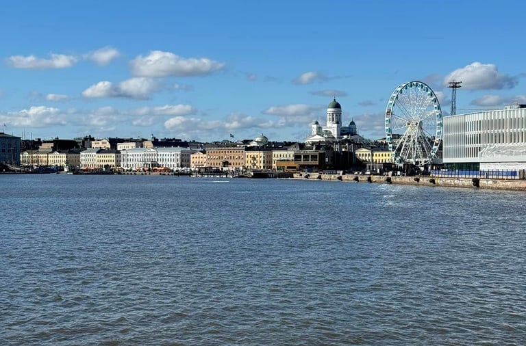 a view of the harbor with a ferris wheel and cathedral in the background