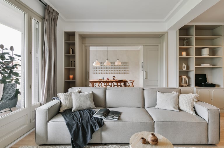 Elegant living room with bespoke wall installation, neutral tones by SAVIA interior design