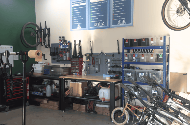 Professional bicycle repair workshop with tools, workbenches, and organized storage shelves.