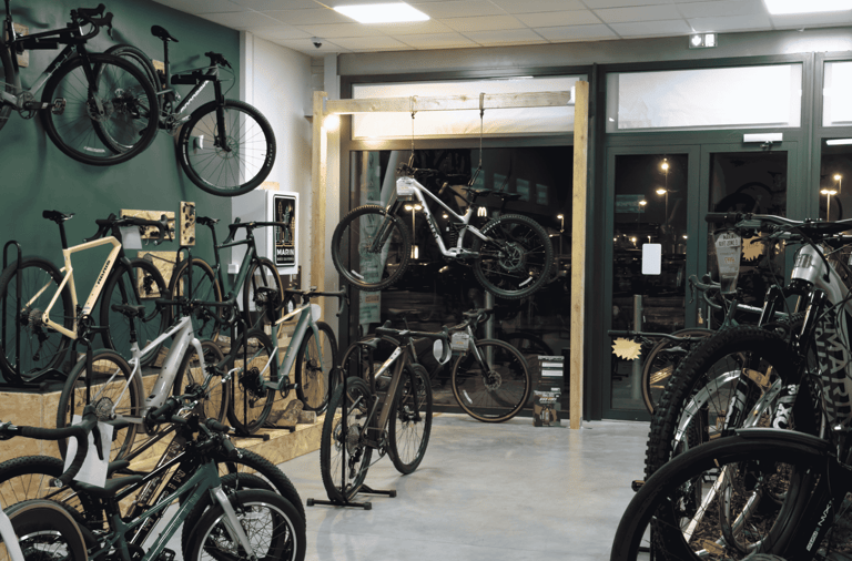 Showroom of a modern bicycle shop featuring rows of mountain bikes and road bikes on display.