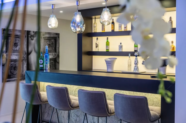 Contemporary home bar with stools at Villa Serenity