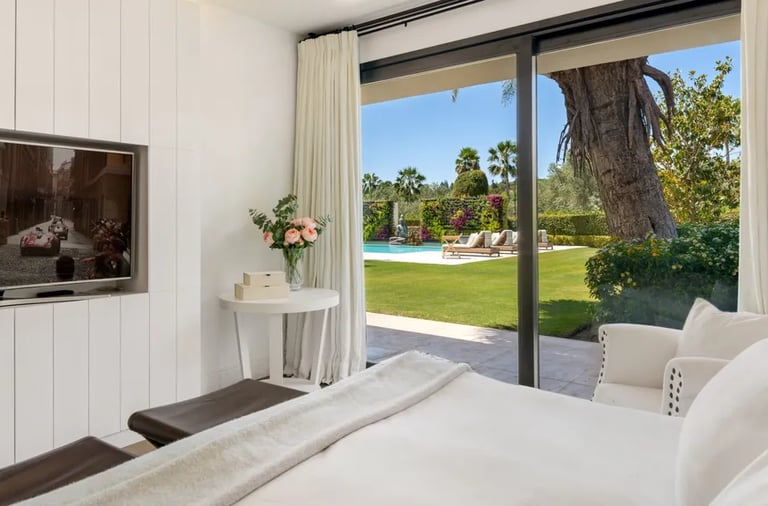 Guest suite with garden views and modern interior design at Villa El Olivo, Marbella