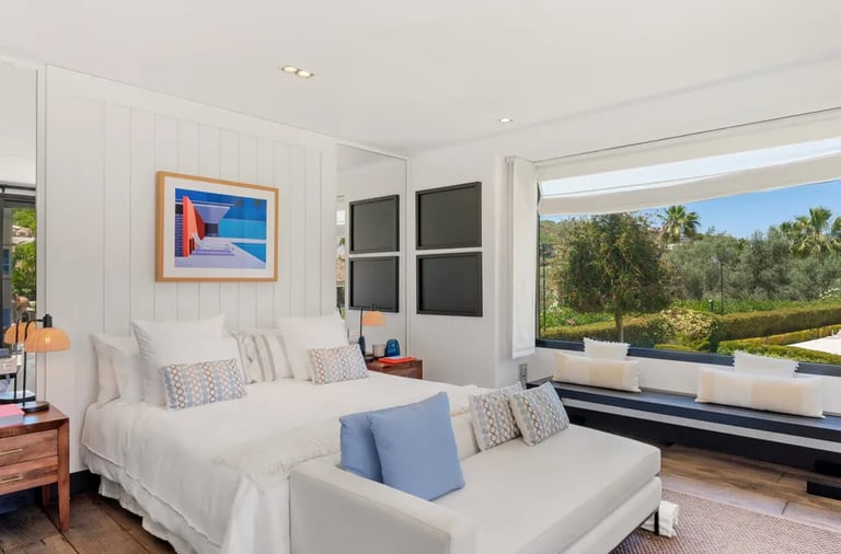 Guest suite with seating nook and garden views at Villa El Olivo, Marbella