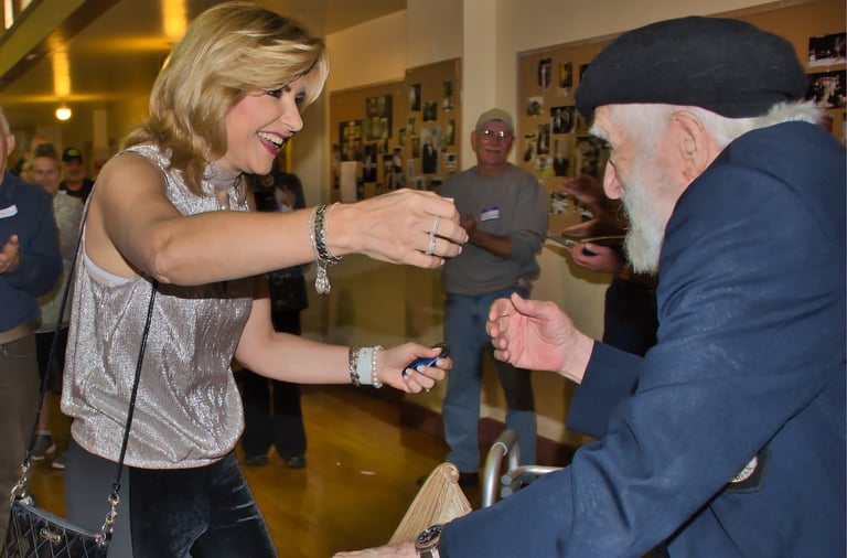a woman is greeting and hugging an old man
