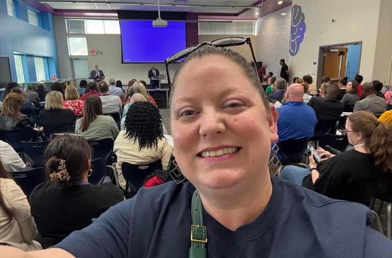 Selfie photo with organization meeting in background