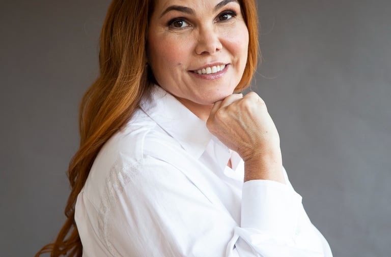 a woman with red hair and a white shirt