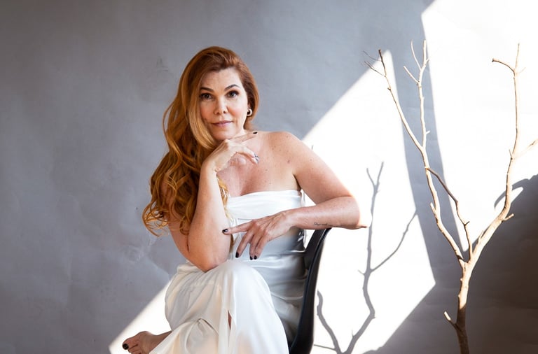 a woman in a white dress sitting in a chair