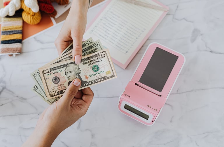 a person holding a stack of money and a cell phone