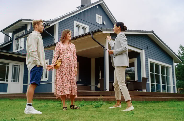 a man and woman standing in front of a house