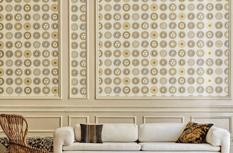 Elegant living room featuring a white boucle sofa and Fornasetti sun motif wallpaper.