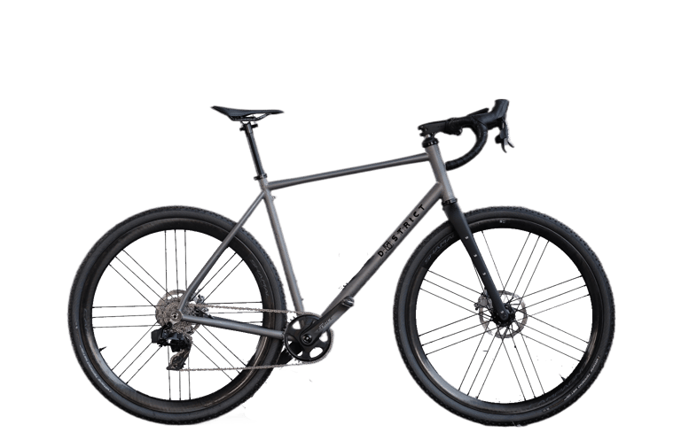 Custom travel titanium gravel bike with carbon wheels and electronic shifting drivetrain Dystrict.