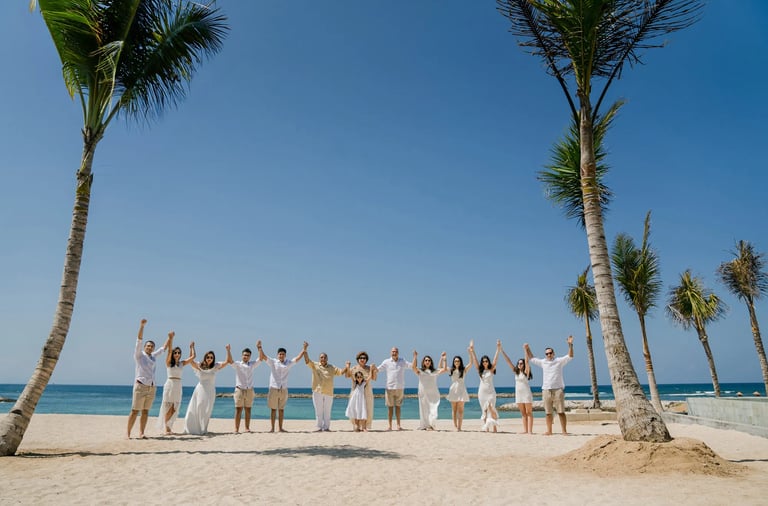 Multi-generation family portrait on the private beach at The Apurva Kempinski Bali