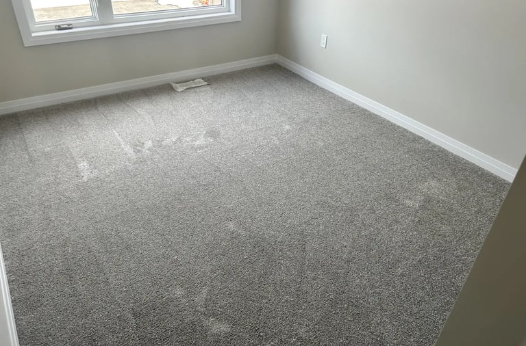 Bedroom with grey plush carpet installed wall-to-wall in Alymer Ontario residential home, soft and cozy flooring