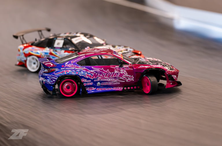 a pink and blue RC car drifting