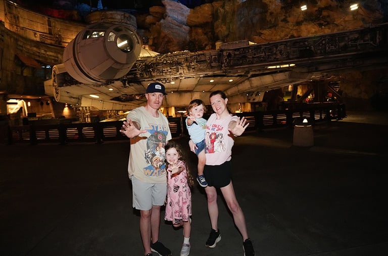 Aimee Cochrane and family pictured in front of the Millennium Falcon inside Star Wars: Galaxy's Edge.