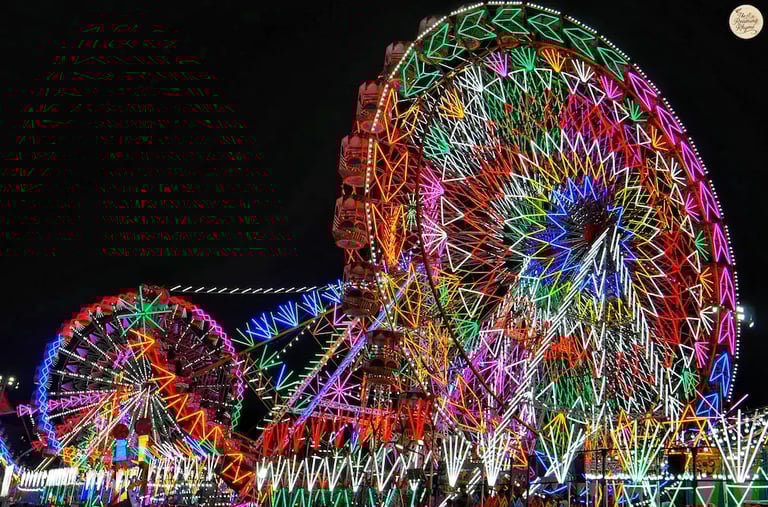 Amusement rides glowing with colorful carnival lights at Kota Dussehra Mela night view.
