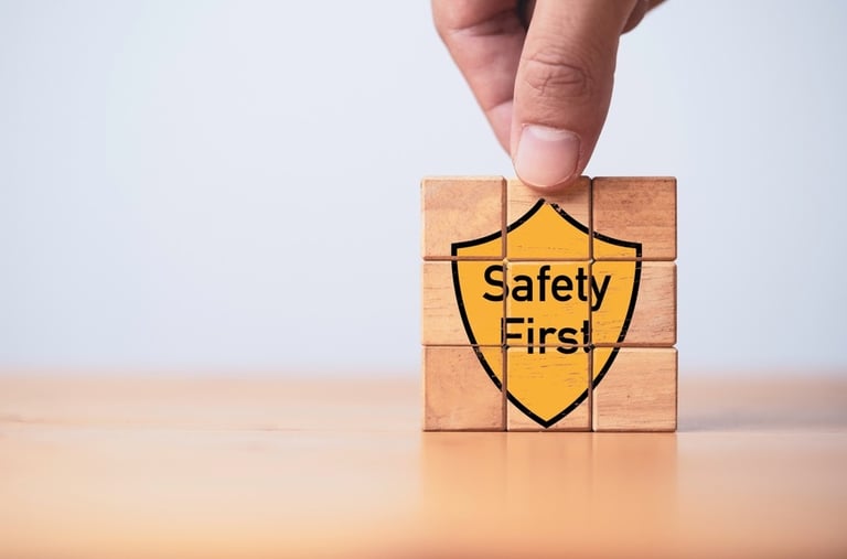 Building blocks with the graphic of a yellow shield saying "Safety First" on the front