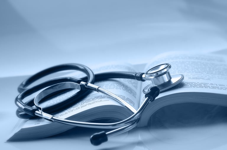 An open medical book with a stethoscope on top of it