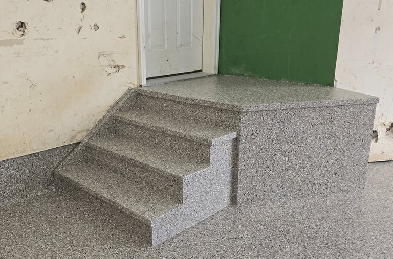 Flake garage floor coating on stairs with seamless cove base