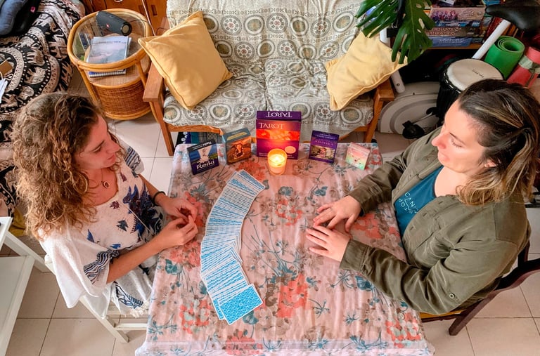 two women sitting at a table with a candlelight