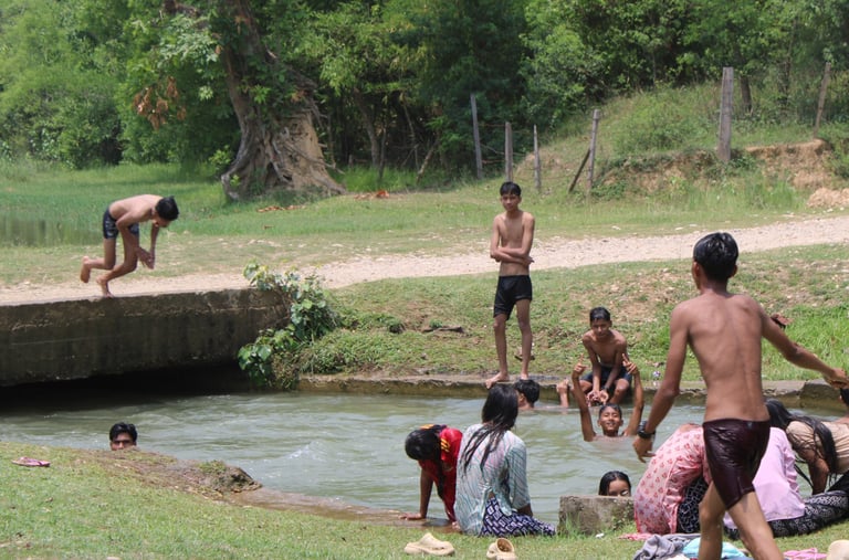 children bathing in the river at Thakurdwara