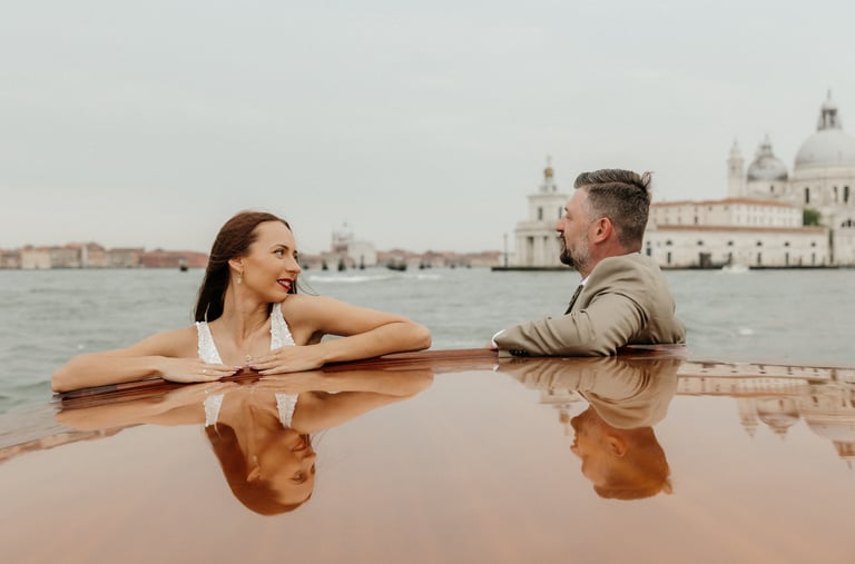 a man and woman sitting on a taxi boat in venice wedding