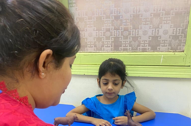 Child interacting with colorful therapy materials
