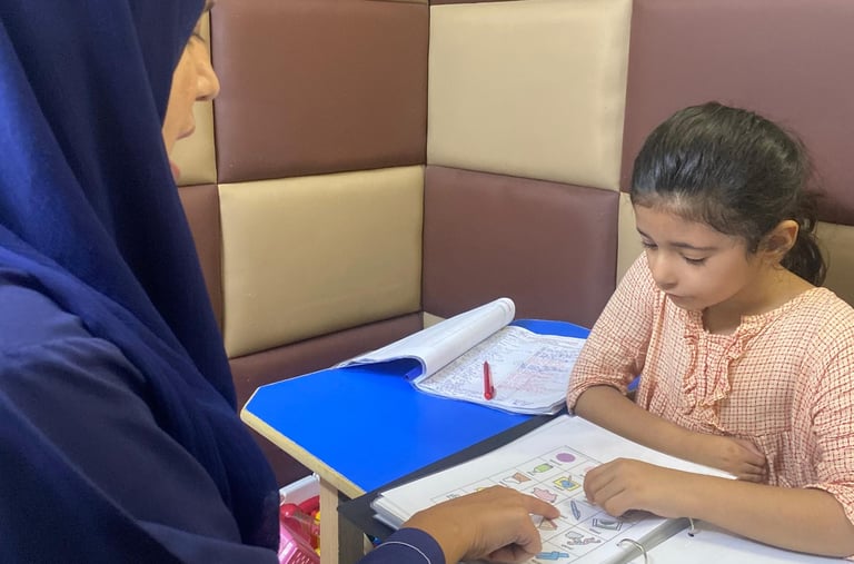 Therapist guiding young girl during session